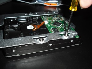 Use the screws attached to the carrier to attach it to the hard drive. This is the only part of the process that requires a tool  a small Phillips screwdriver.